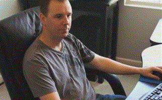 Local business owner at a desk hopefully clicking around, waiting for customers to find them.